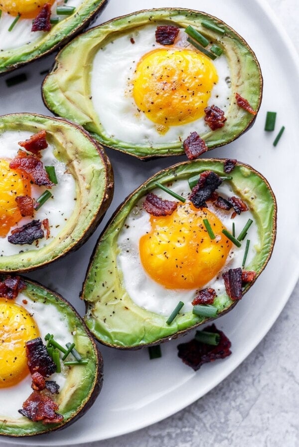 Avocado Egg Bake topped with bacon and chives.