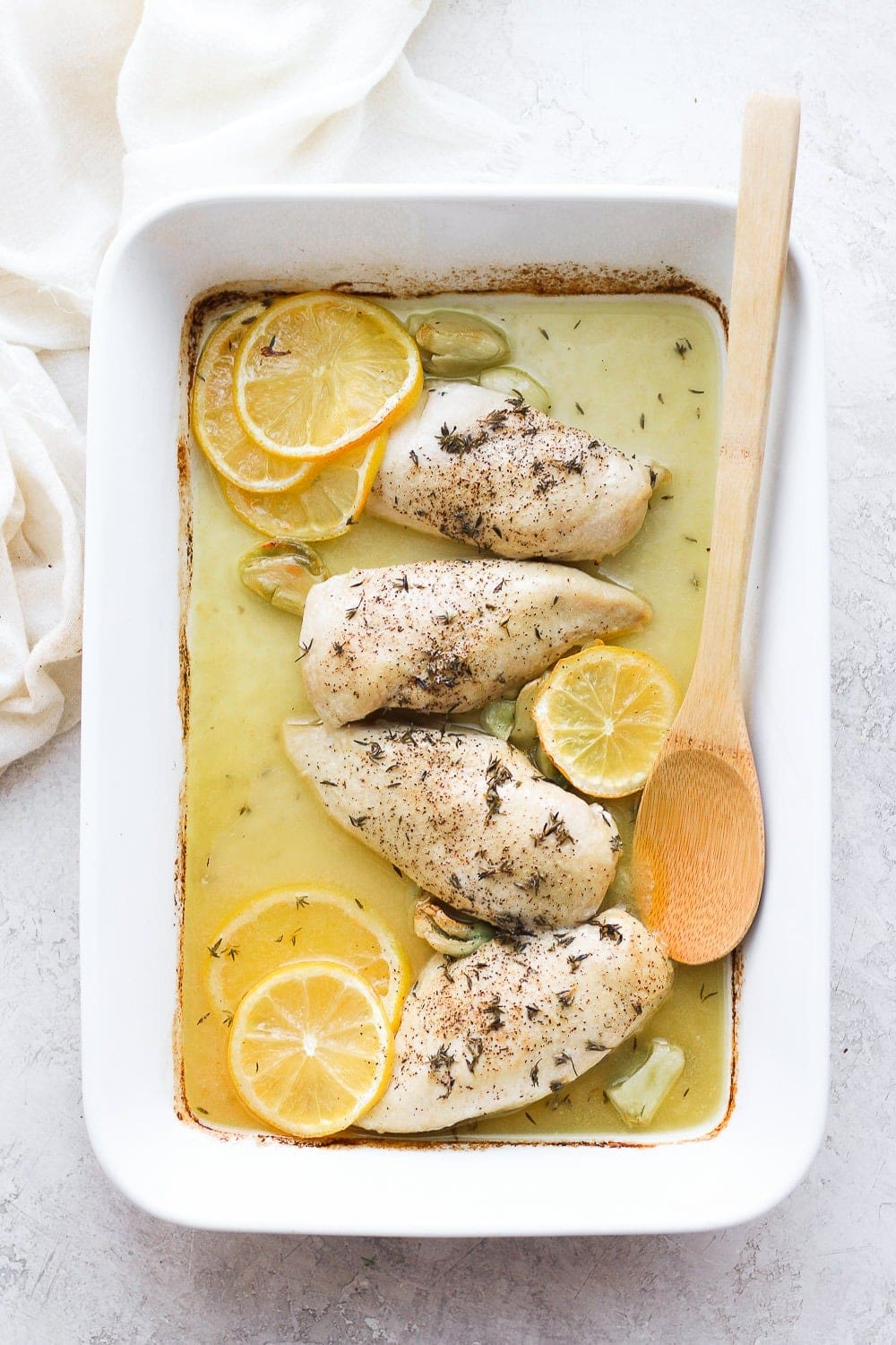 Baked lemon chicken in c،erole dish.