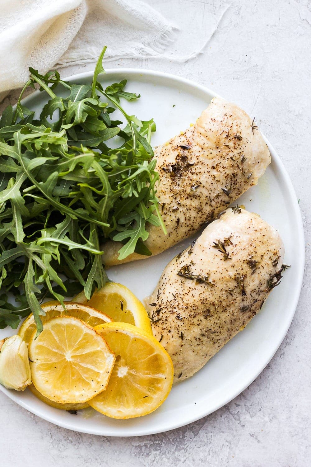 Baked Lemon chicken ، on plate.