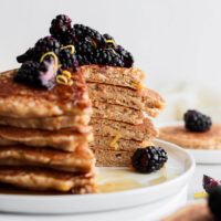 healthy lemon ricotta pancakes stacked and topped with blueberries