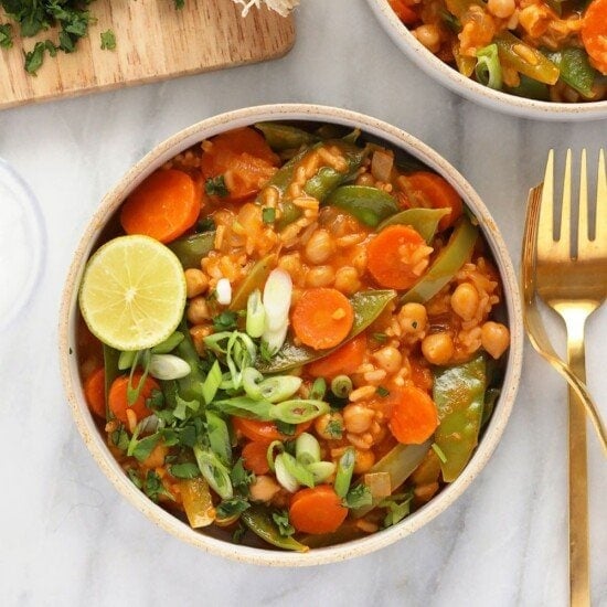 a bowl of Thai chickpea curry with a fork.