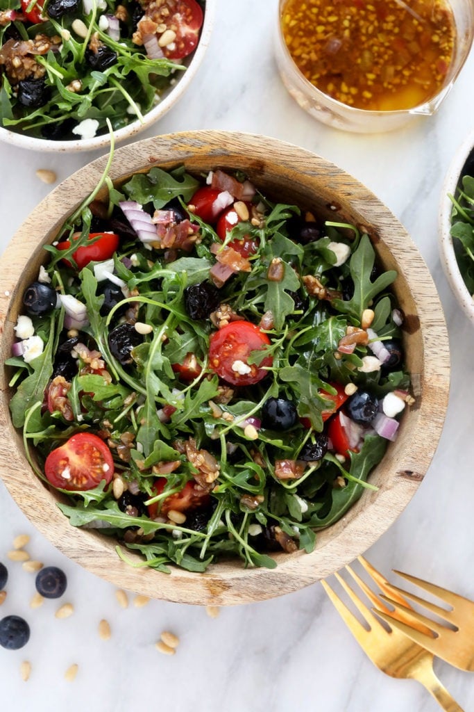 Arugula Salad in a mixing bowl. 