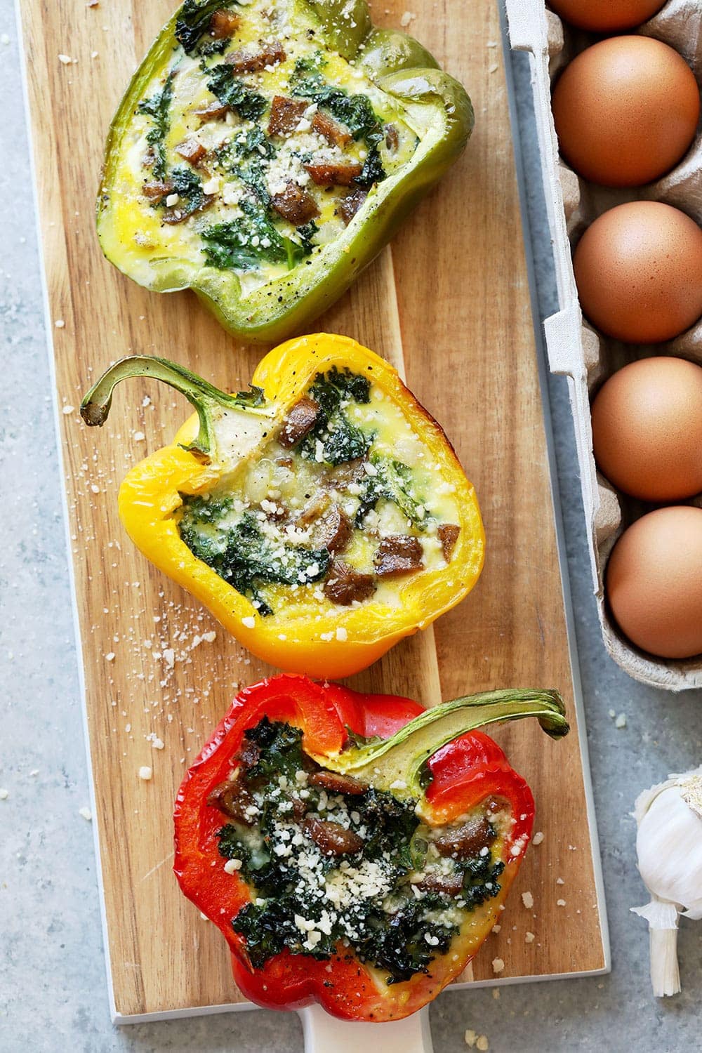 Cheesy Breakfast Sausage Stuffed peppers on a cutting board