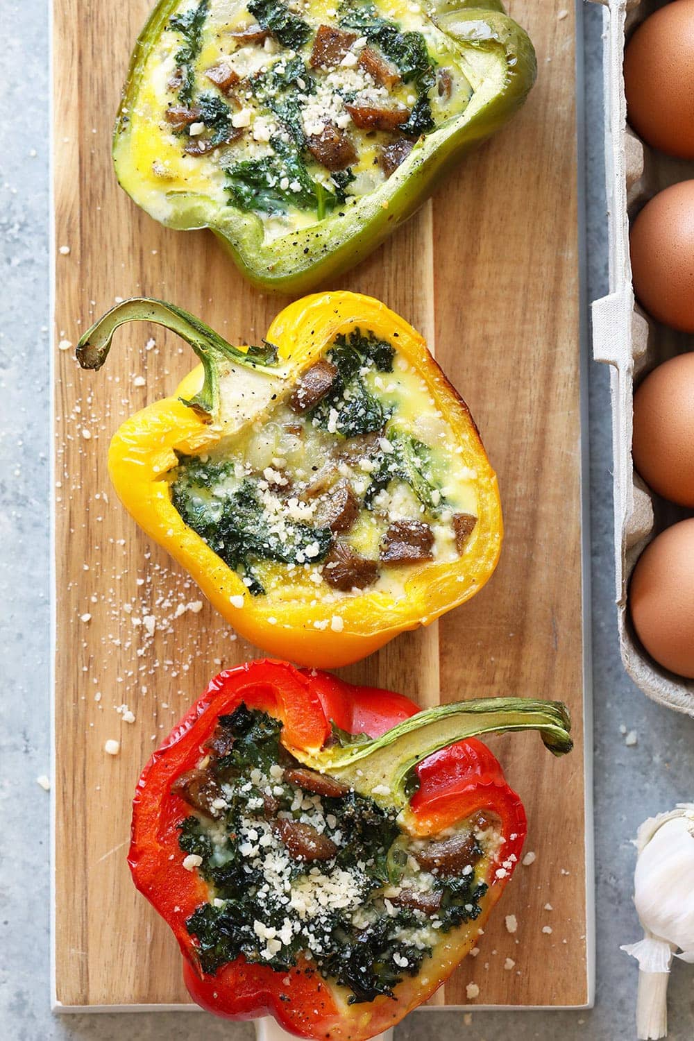 Breakfast sausage stuffed peppers on a cutting board