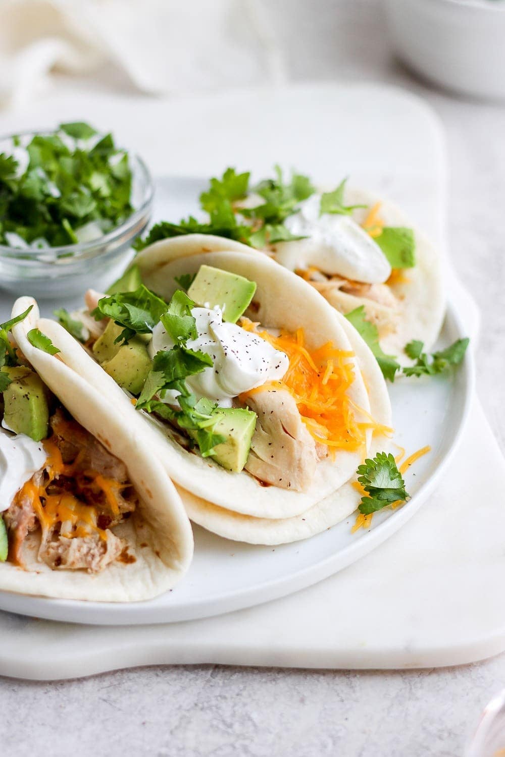 shredded chicken tacos on a plate