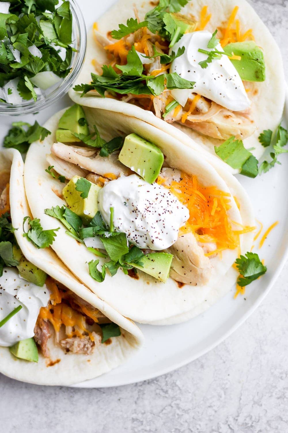 shredded chicken tacos on a plate and ready to be served
