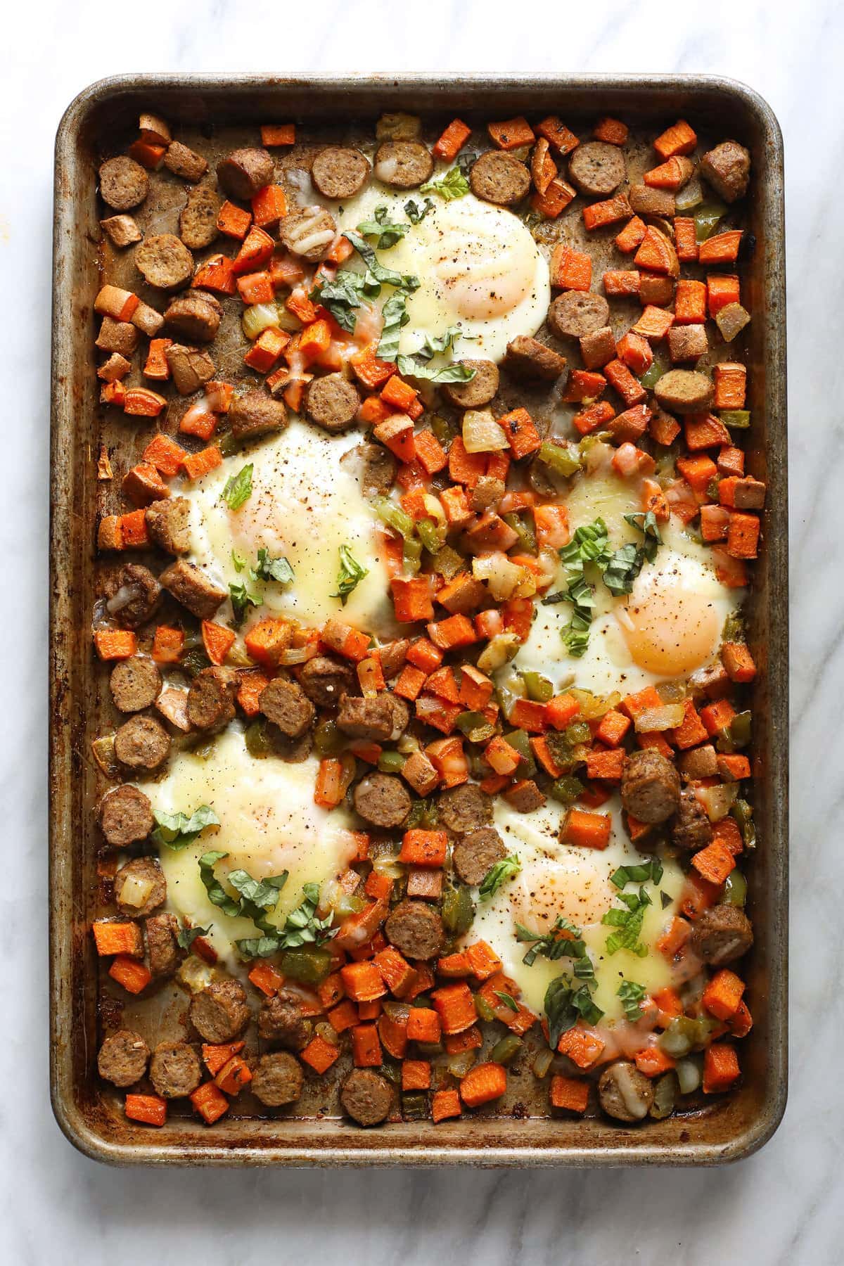 sheet pan with sweet potato hash and baked eggs.