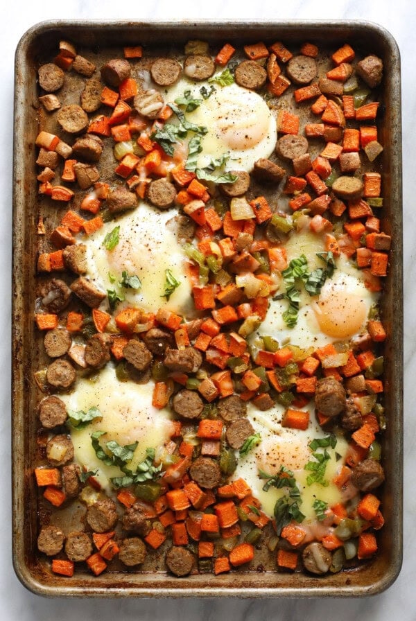 sweet potato hash on baking sheet with baked eggs