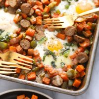 sweet potato hash with eggs on sheet pan with forks