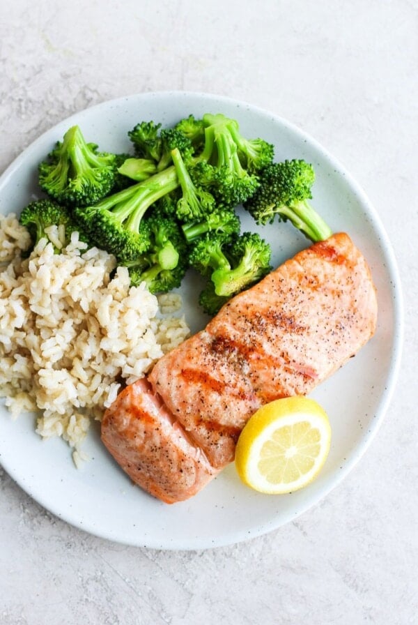 grilled salmon on a plate with a slice of lemon