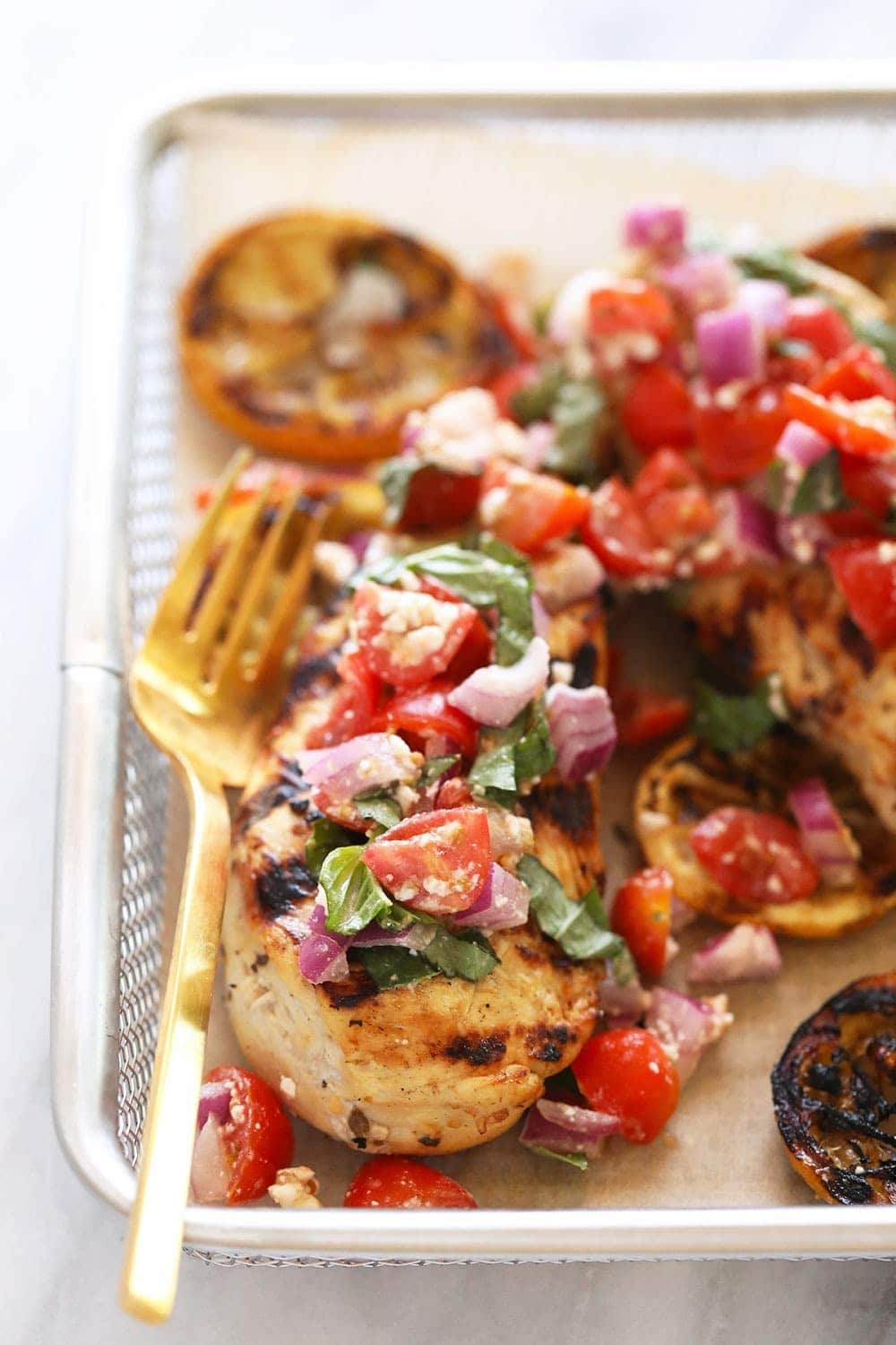 Lemon Greek chicken with fresh tomatoes on top. 