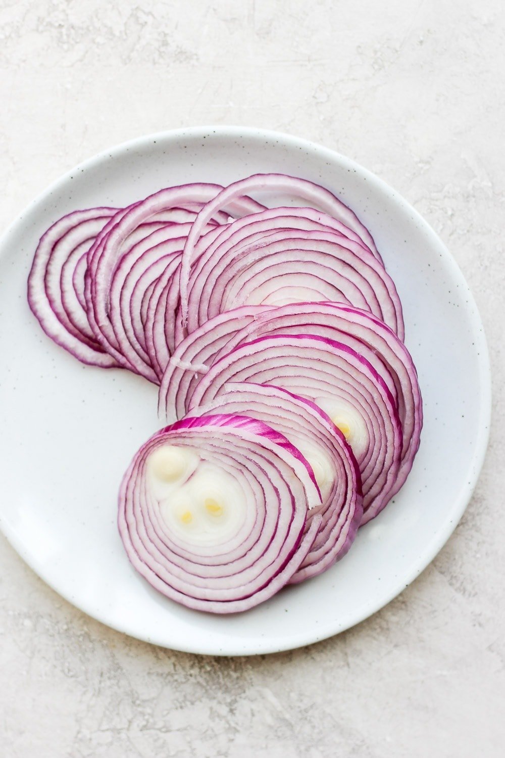 Raw onions on a plate. 