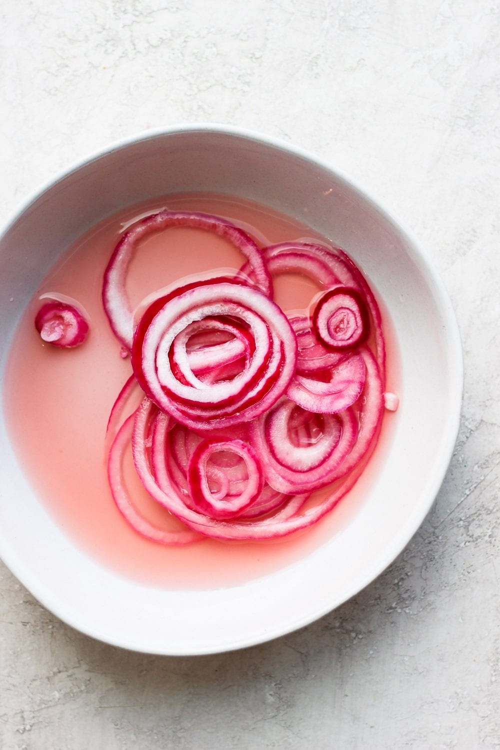 Pickled onions in a bowl.