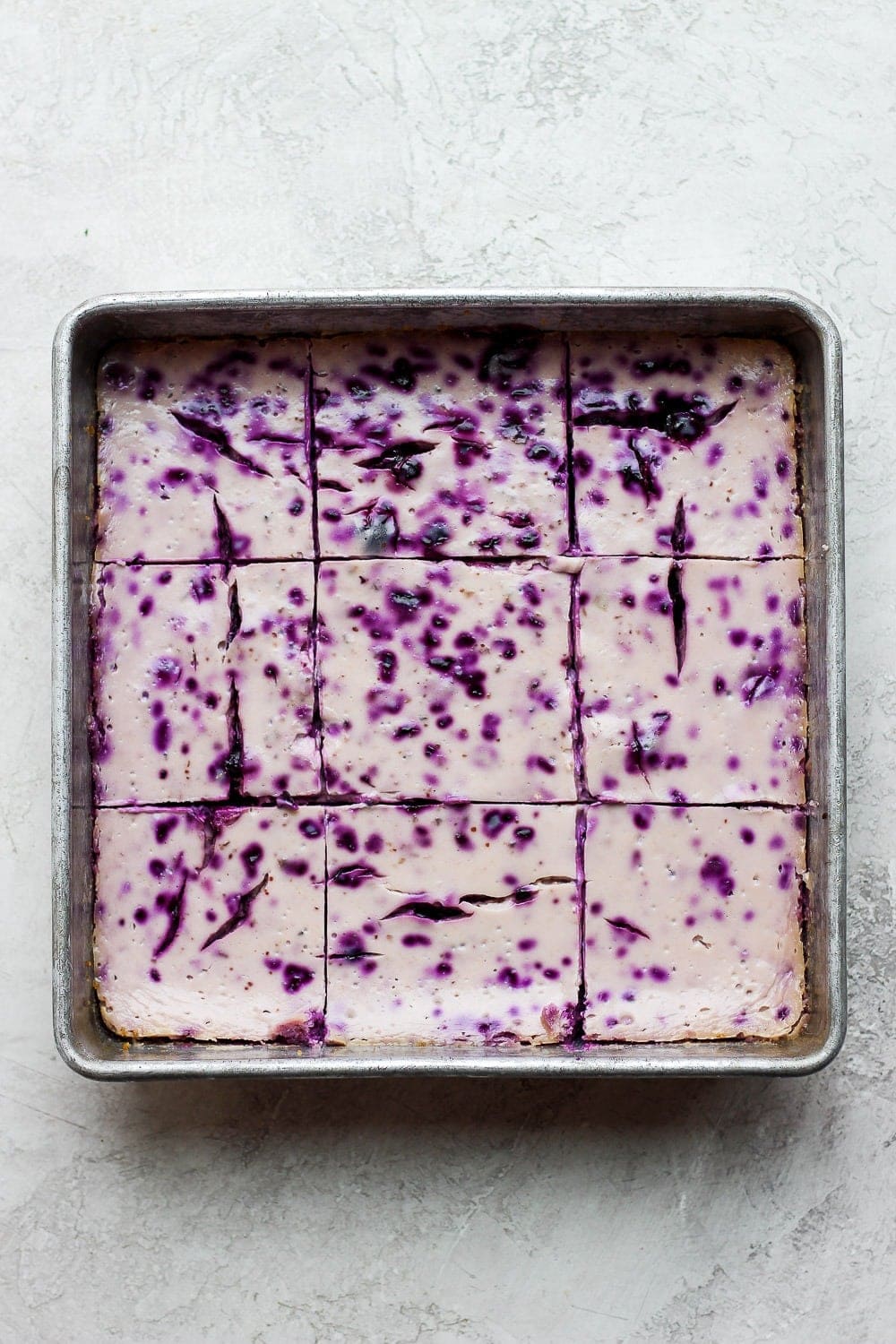 blueberry cheesecake bars after baking in a square baking dish.