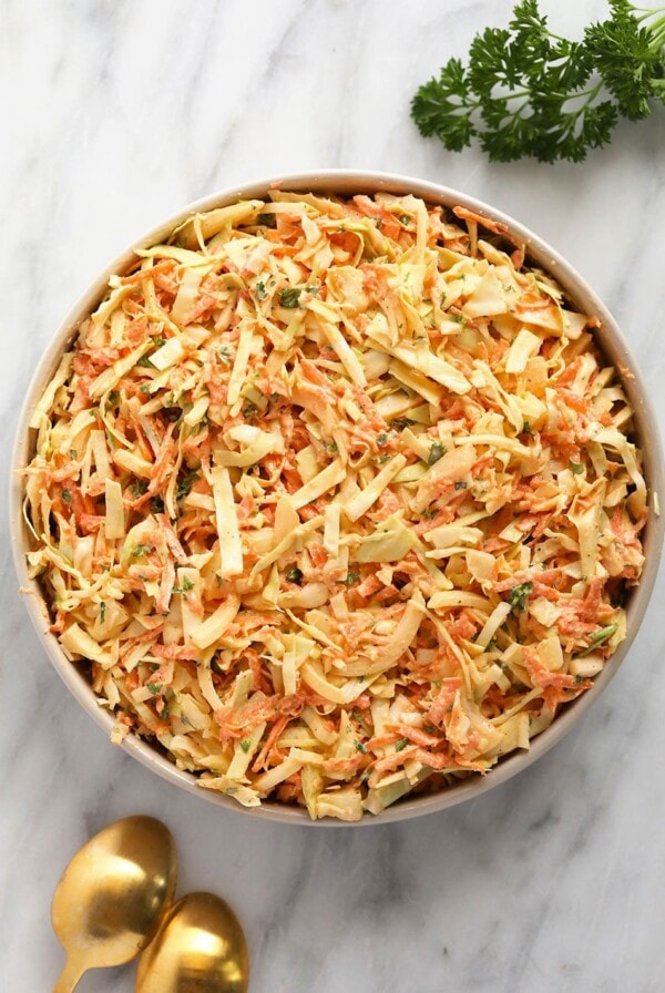 creamy coleslaw with cabbage and carrots topped with parsley