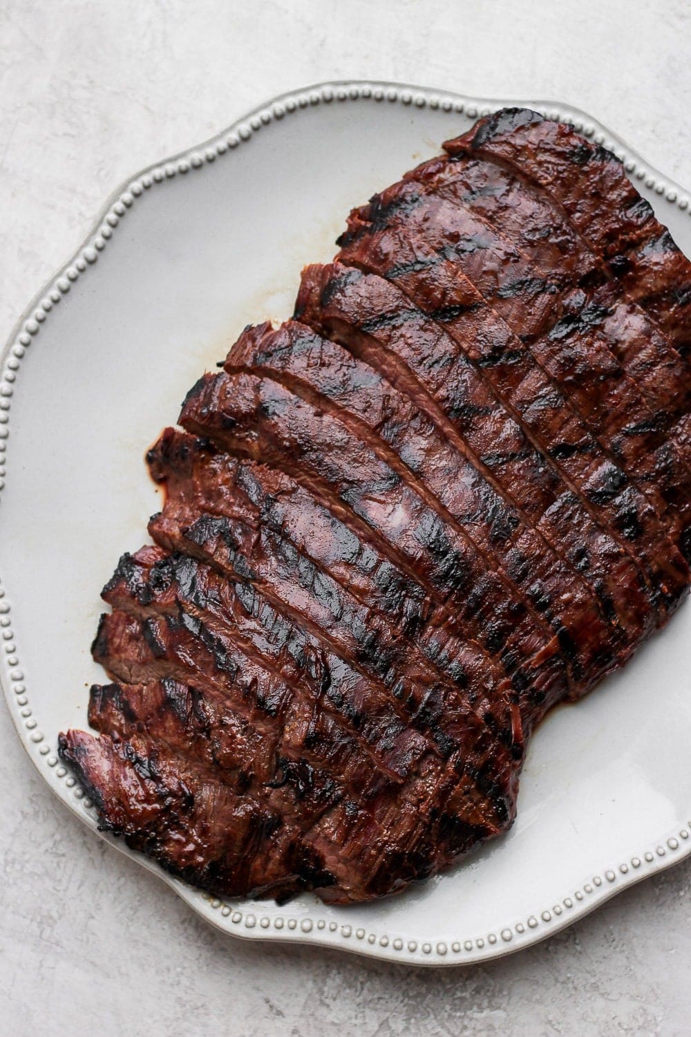 Grilled flank steak on a plate that is cut into strips! 