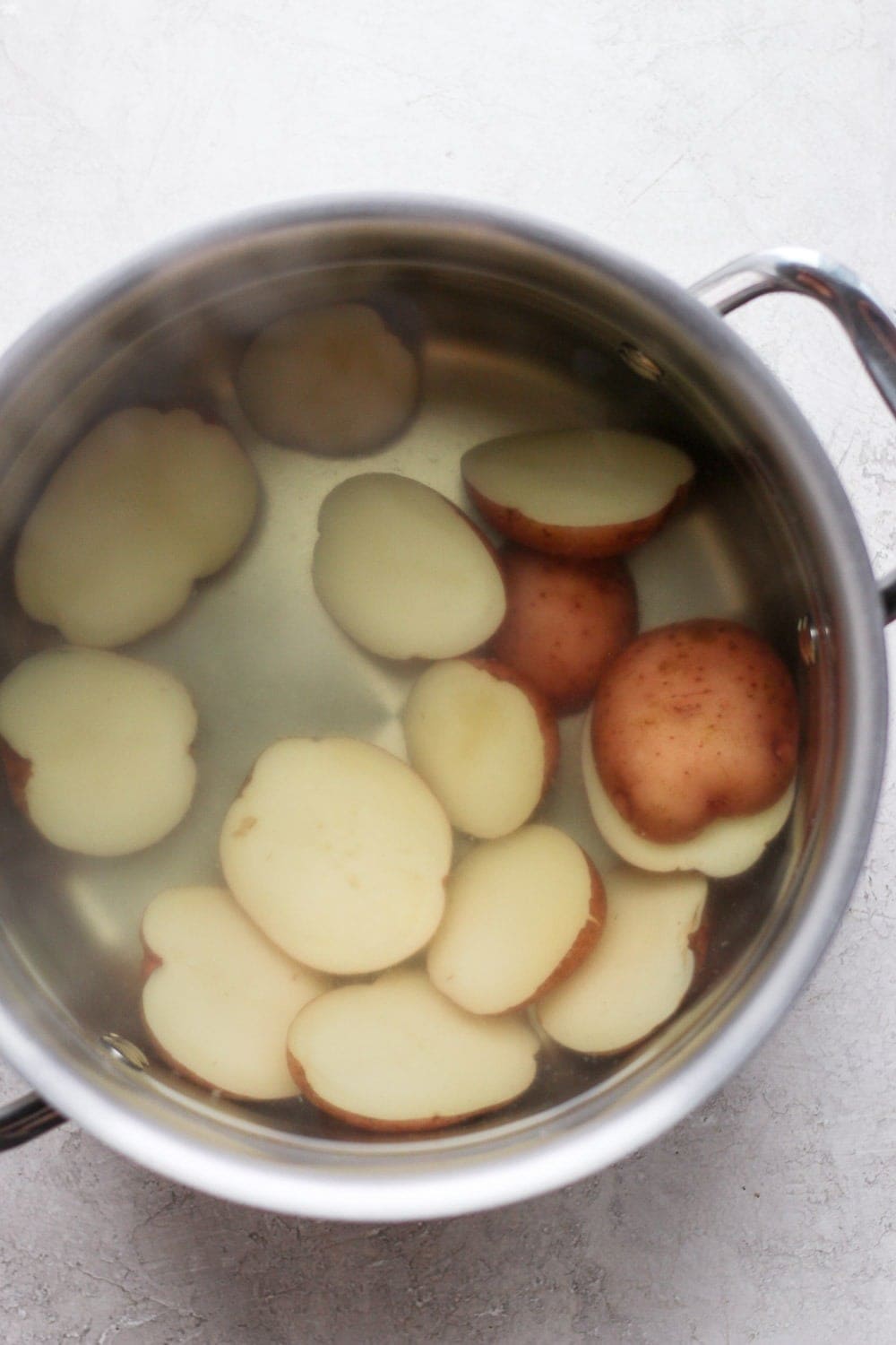 Boiling red potatoes in a large pot of water. 