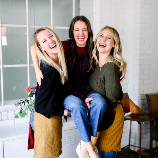 Three fit foodie women posing for a photo in a kitchen.
