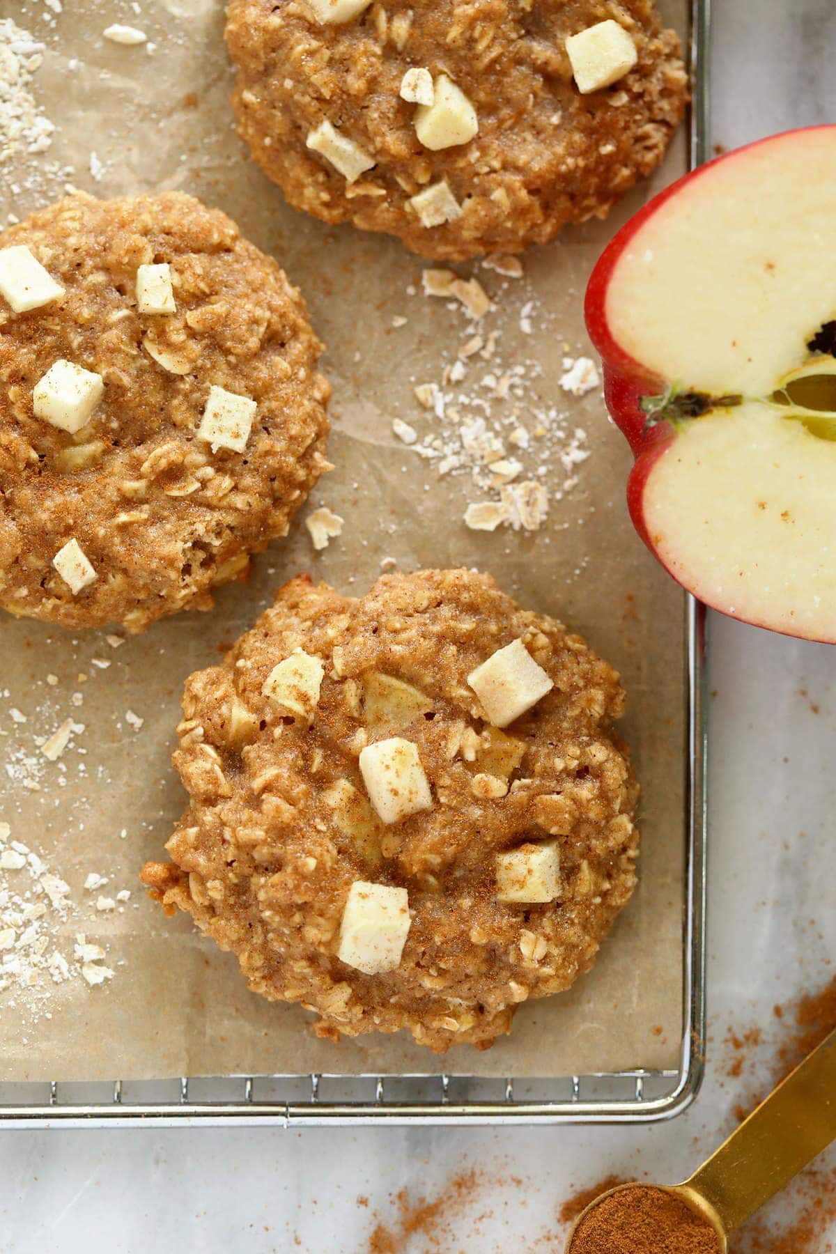 Baked apple oatmeal cookies on a cooling rack. 