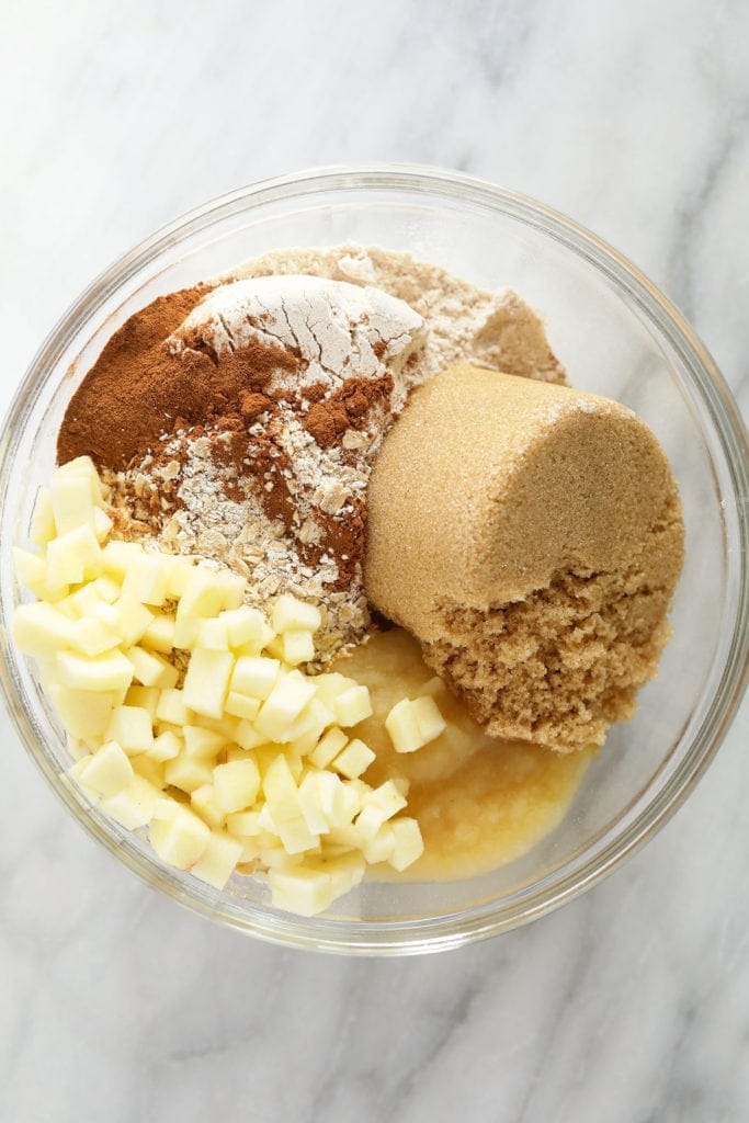 All of the ingredients for the apple oatmeal cookies in a bowl. 