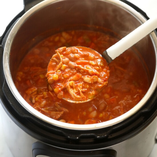 An Instant Pot full of buffalo chicken chili with a spoon in it.