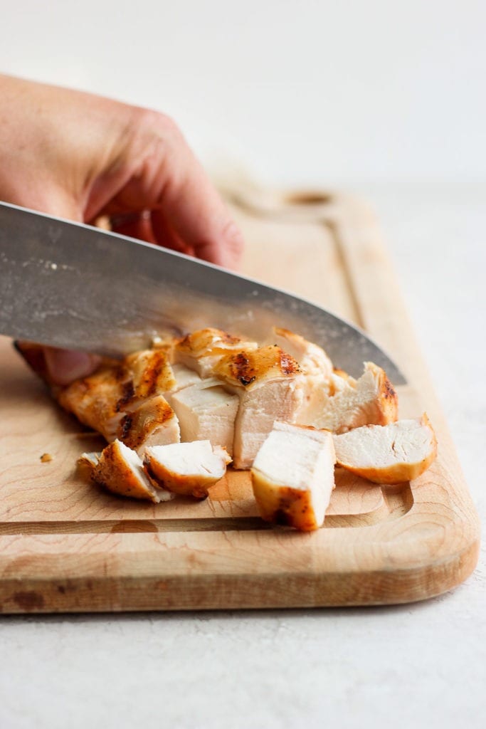 cubed chicken breast on cutting board.
