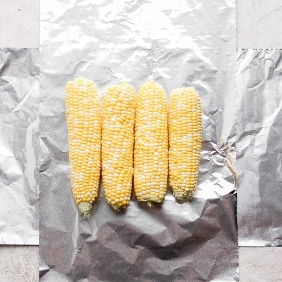 Grilled corn wrapped in foil.