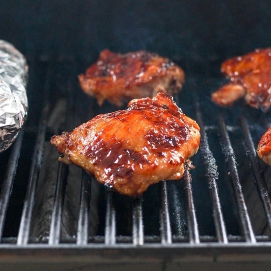 bbq chicken thighs on grill grates.