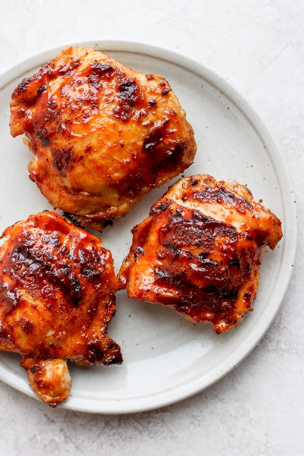 grilled chicken thighs on plate.