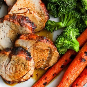 grilled pork tenderloin with carrots on plate