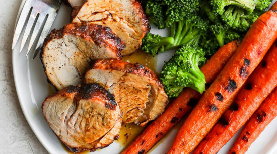 grilled pork tenderloin with carrots on plate