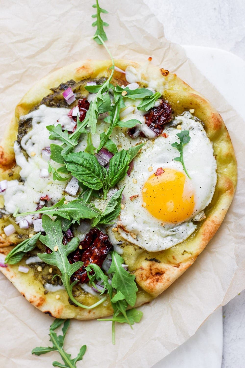 Naan breakfast pizza on a plate. 