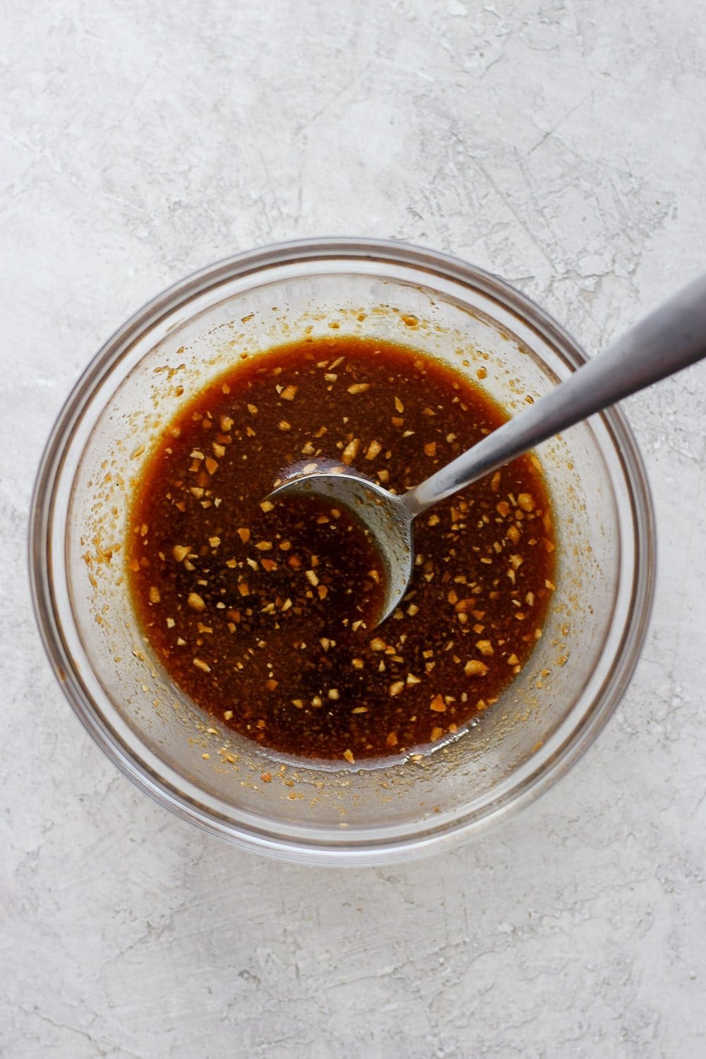 sauce for sheet pan salmon stir fry being stirred in a bowl