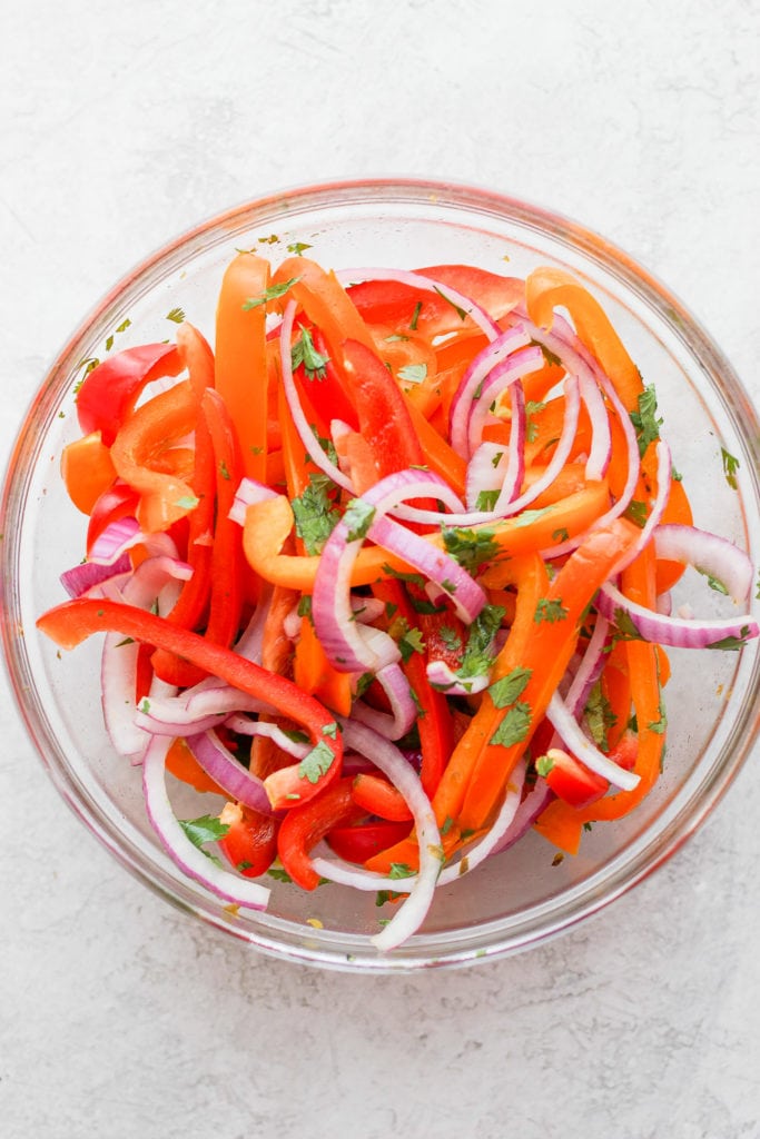 sweet pepper slaw being mixed together in a bowl