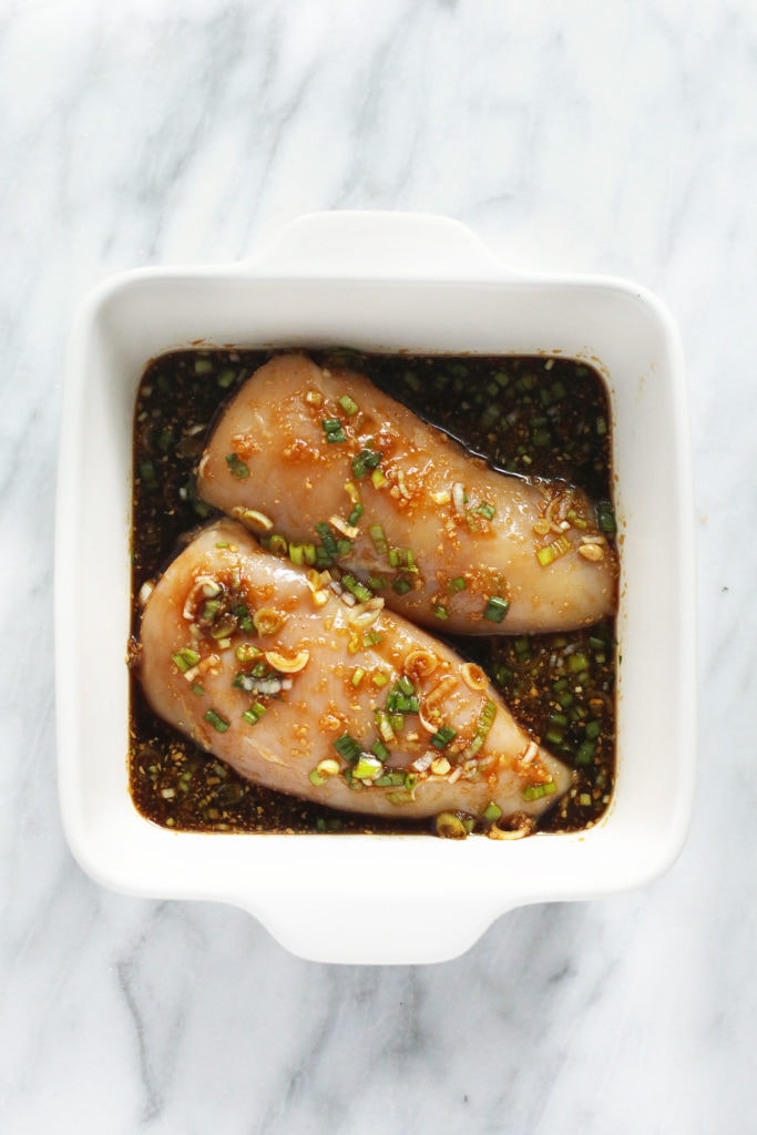 chicken breasts marinating in teriyaki sauce.