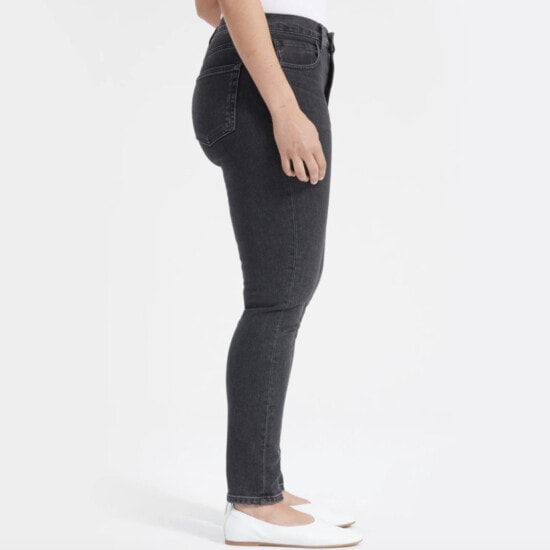 the back view of a woman wearing a pair of black jeans.