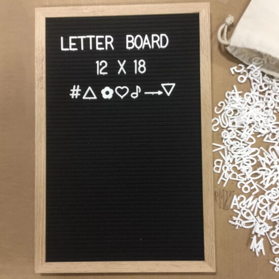 a letter board with letters on it and a bag next to it.