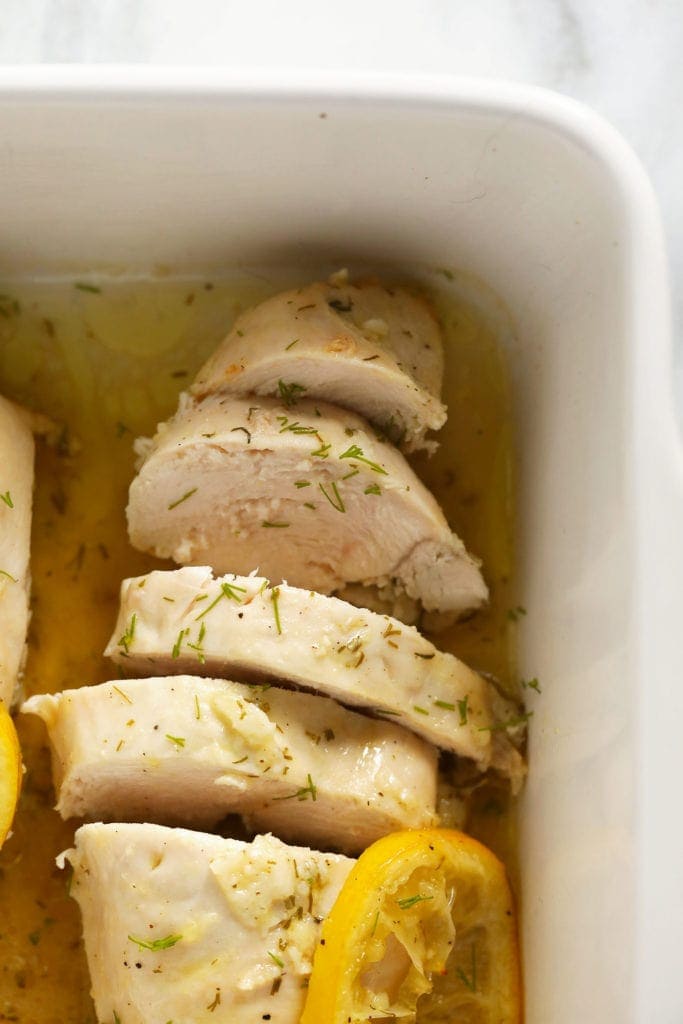 sliced lemon chicken in a baking dish