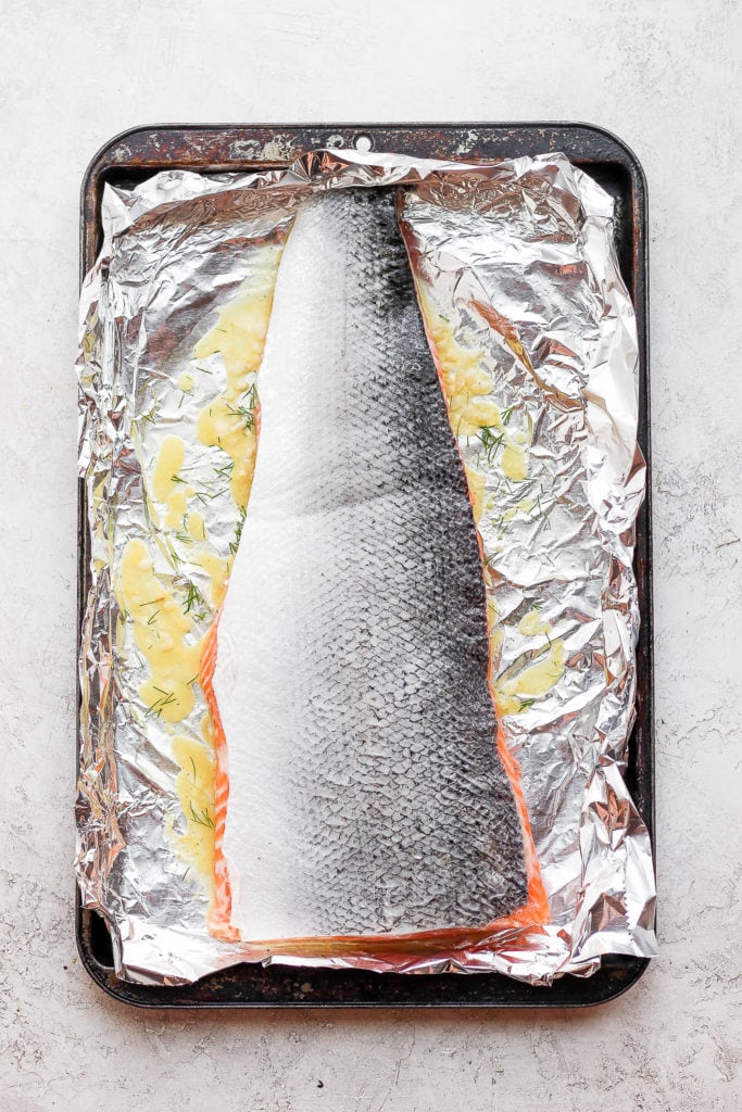 Salmon marinating in a baking sheet. 