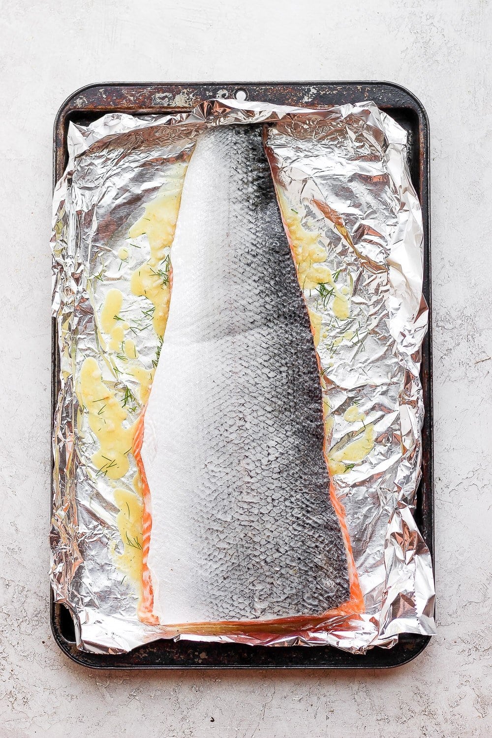 Salmon marinating in a baking sheet. 