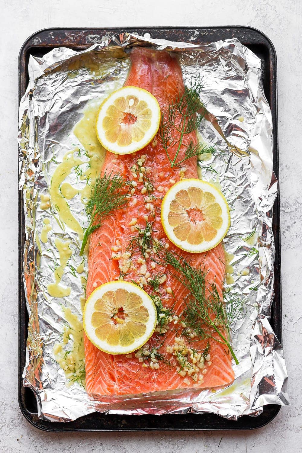 A full salmon fillet marinating