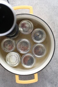 A pot filled with sous vide egg bites, each jar sealed with a lid.