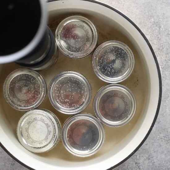 A pot filled with sous vide egg bites, each jar sealed with a lid.