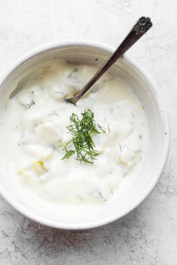A bowl of yogurt with dill.