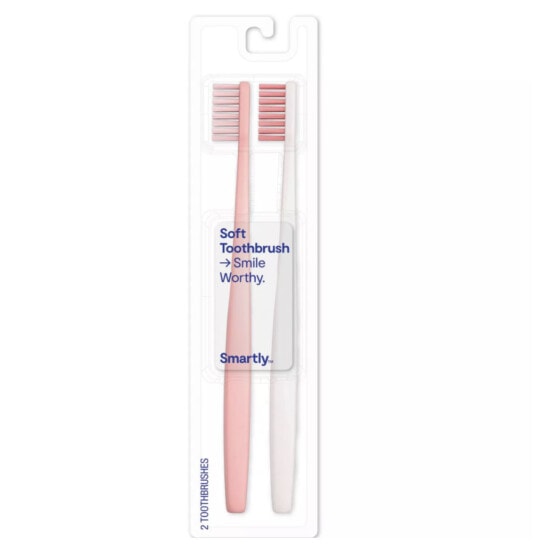 two pink and white toothbrushes in a package.