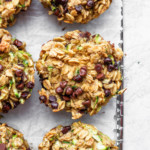 zucchini chocolate chip muffins on a baking sheet.