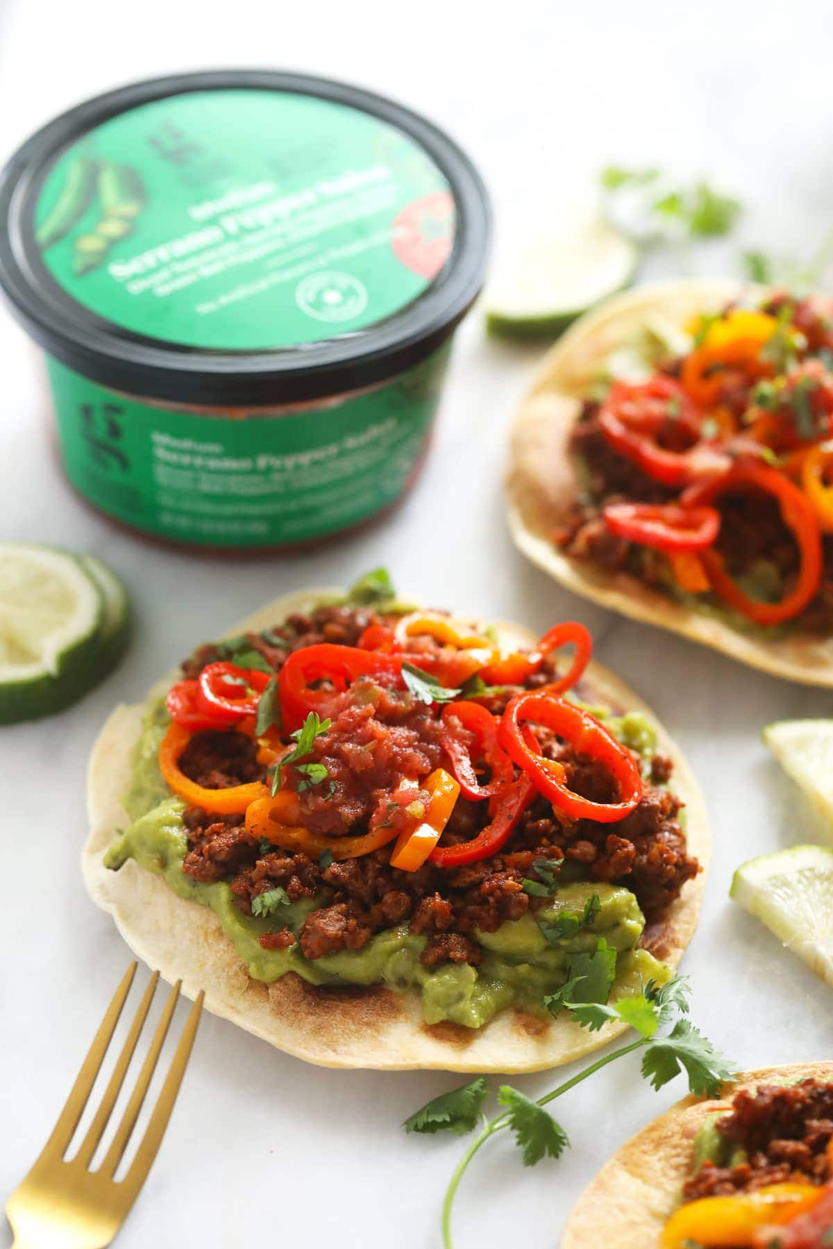 tostada with guacamole, plant based ground, and mini sweet peppers