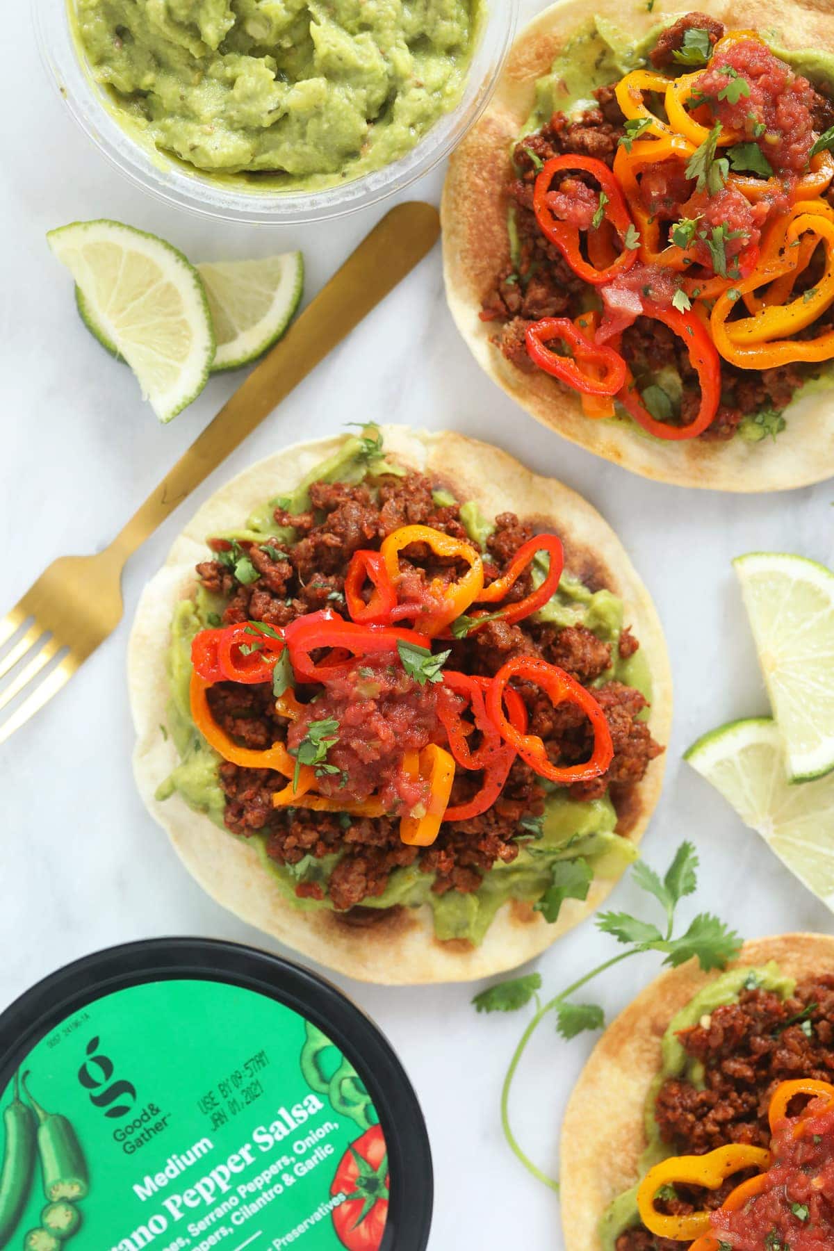 tostada with lime wedges and mini sweet peppers