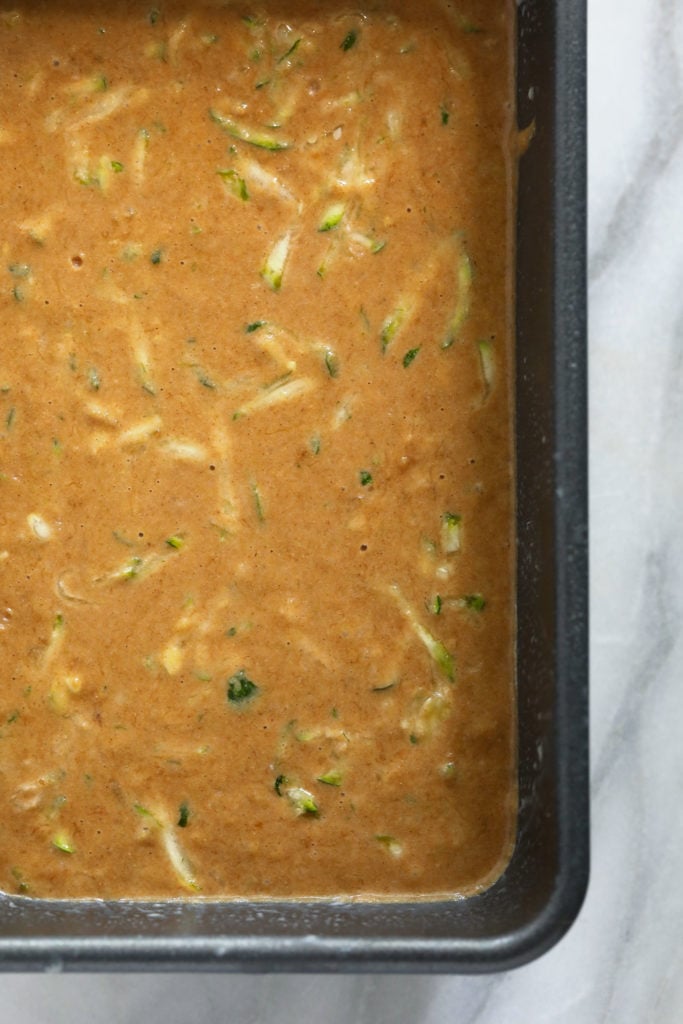 Zucchini bread batter in a loaf pan.