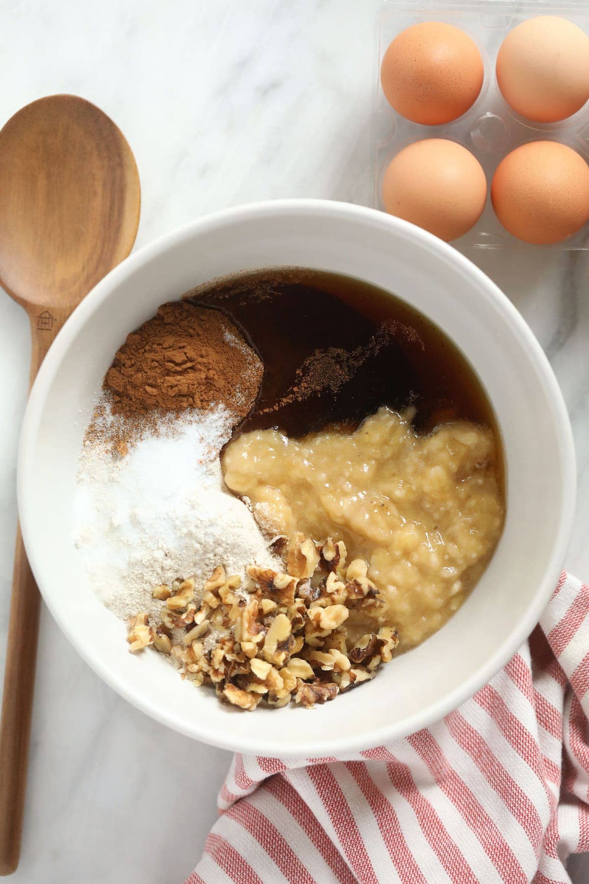 All of the ingredients for the banana nut muffins in a bowl. 